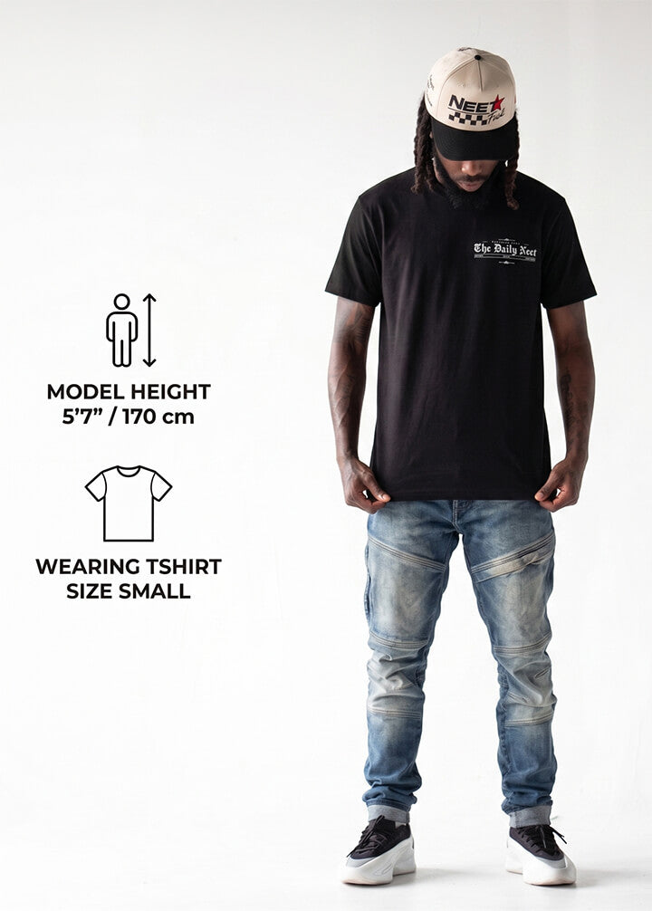 Person wearing a black t-shirt and blue jeans with text on the shirt, model height and size information displayed.