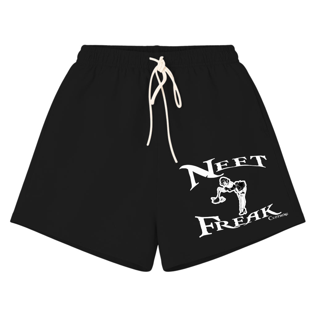 Black athletic shorts with a white drawstring and a white graphic print on the left leg that reads 'NEET FREAK' with a stylized figure, shown on a plain white background.
