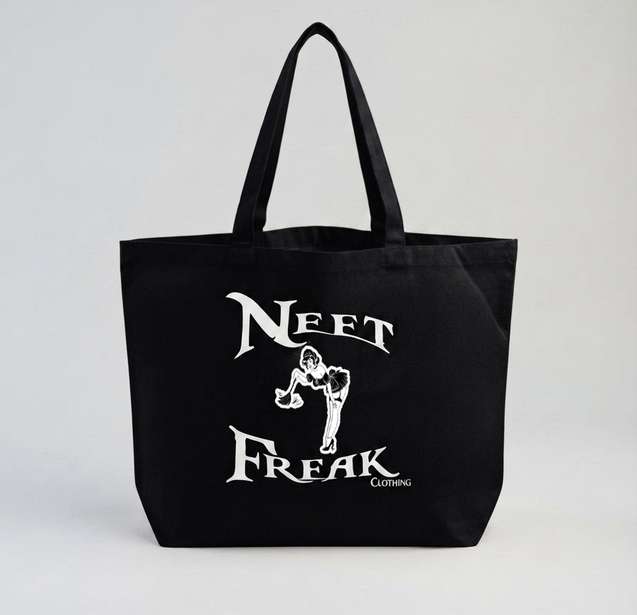 A black canvas tote bag with long handles, featuring a white graphic print on the front that reads 'NEFT FREAK' with a stylized figure and small 'CLOTHING' text, shown against a light gray background.