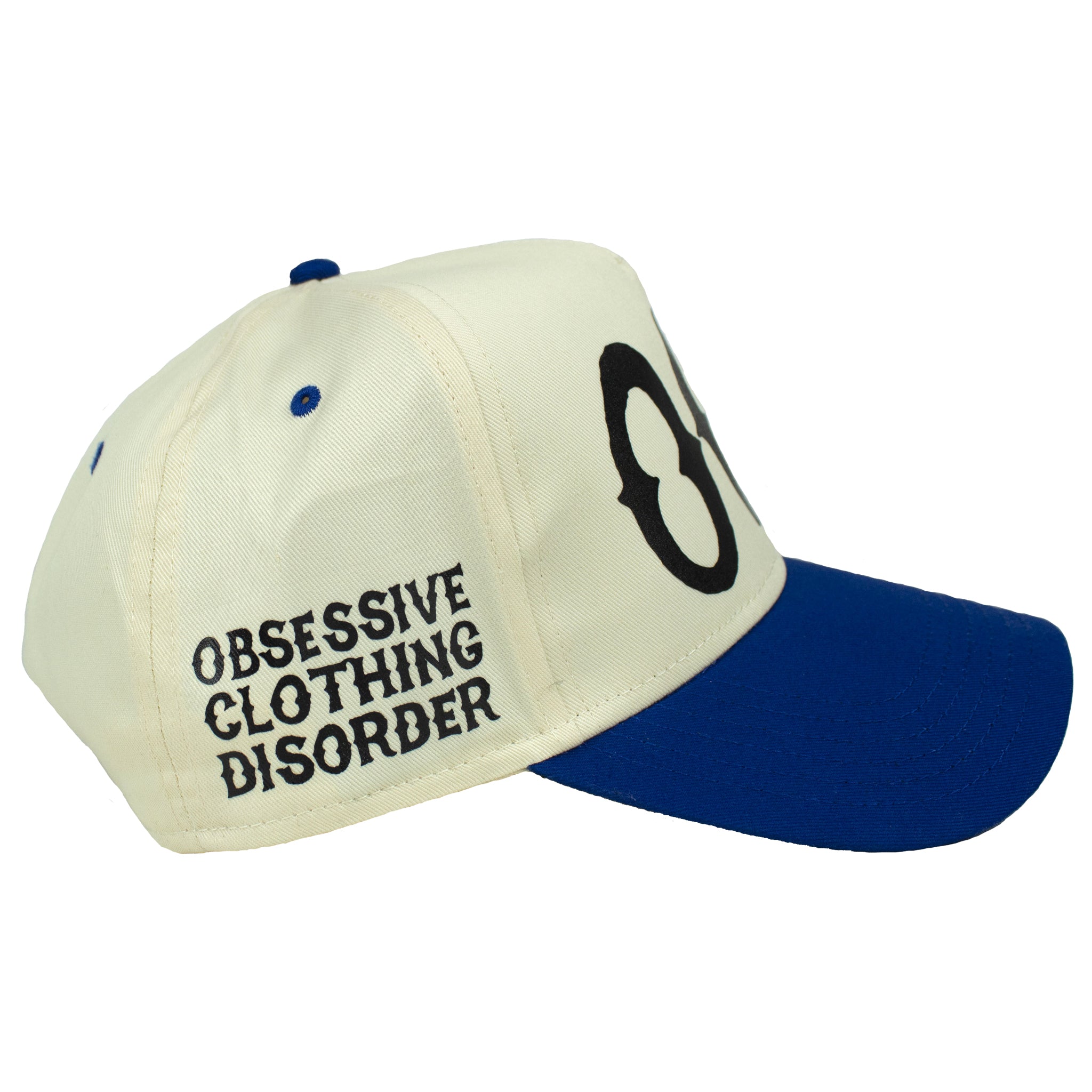 Right of Premium natural and royal blue trucker hat with Black printed 'OCD' acronym, standing for Obsessive Clothing Disorder.