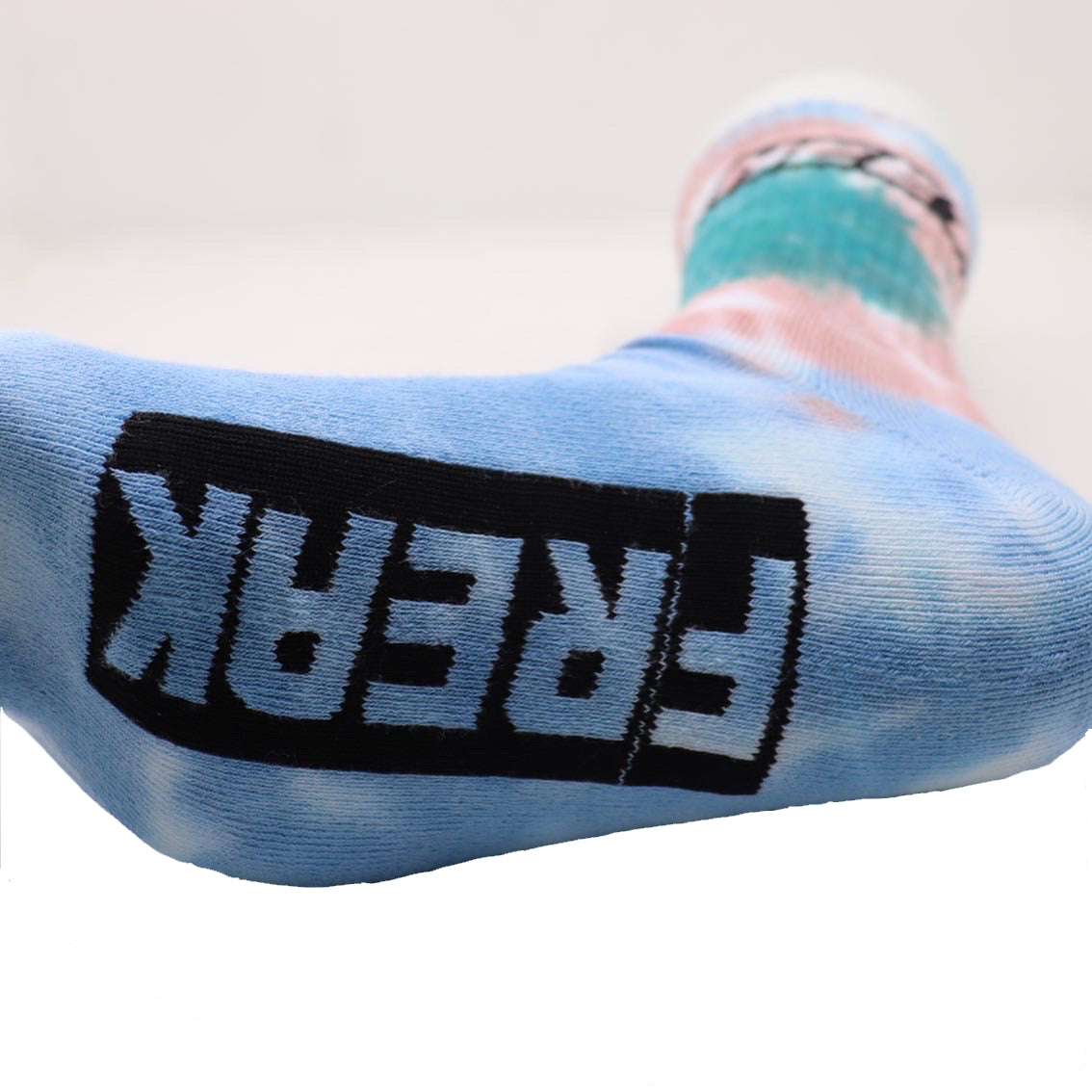 Bottom view of the Neet Freak men's tie-dye socks, showcasing the stitched Freak on the bottom of the sock